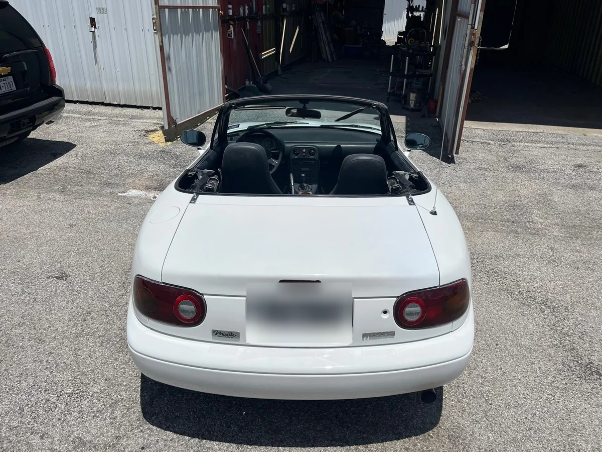 Restored Miata from the rear, finished in white