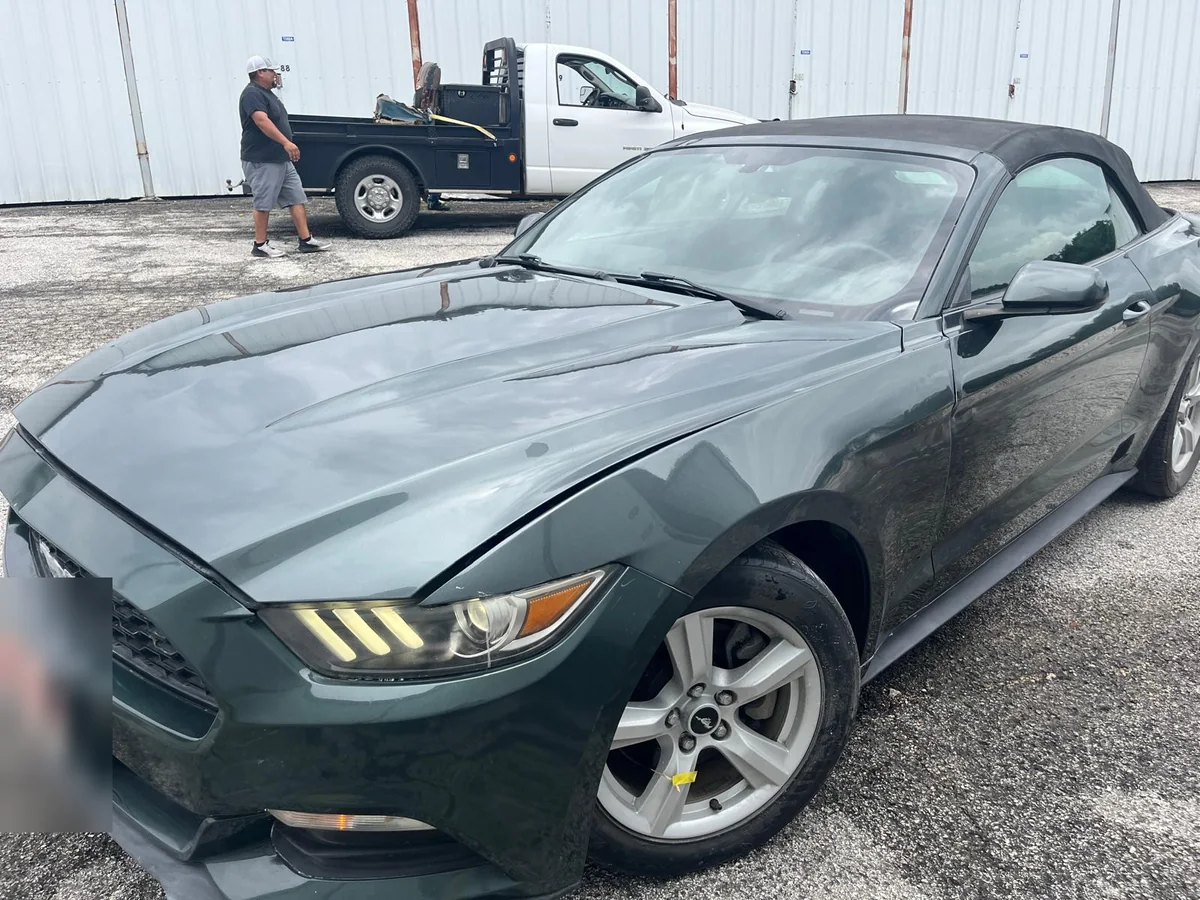 Dark green Mustang convertible, front and side, after the work